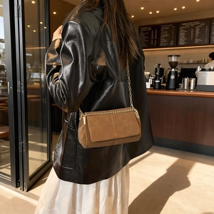 Brown vintage suede crossbody bag with metal chain strap and cross stitching detail