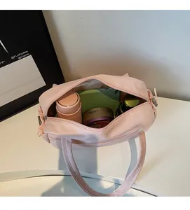 Top view of pink canvas tote showing large capacity storage with zipper and handles