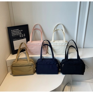 Detail showing high-capacity canvas bags in five colors with zipper pockets