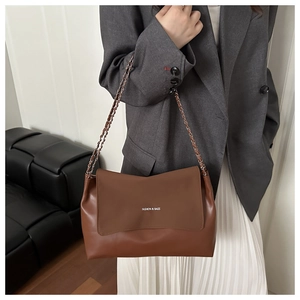 Brown leather tote bag featuring a metal chain strap and white FASHION & BAGS lettering