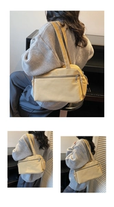 Detail of ginger yellow nylon tote bag featuring front zip pocket and wide shoulder strap