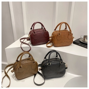 Detailed display of vintage bowling bags in multiple colors on minimalist pedestals