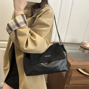 Vintage black PU leather tote bag with chain strap shown on a model for daily use