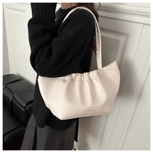 Detailed side view of off-white ruched cloud bag with Fashion Bags logo on strap
