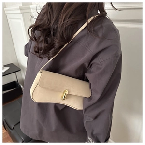 Detail showing beige leopard texture and curved base of the hourglass shoulder bag