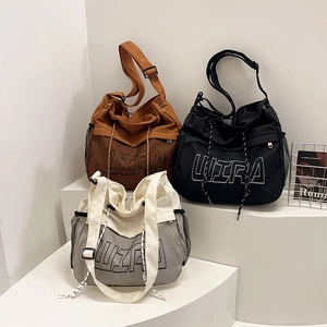 Canvas and mesh patchwork tote bag with ULTRA lettering and adjustable shoulder strap
