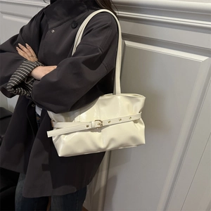 Minimalist creamy white underarm tote bag in glossy patent leather with buckle detail