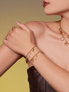 Model wearing gold sea turtle and seahorse necklaces and bracelets with sparkly zircons