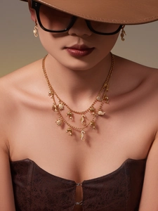 Detail of gold layered necklace and seahorse earrings set with sparkling crystals