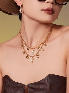 Golden ocean theme jewelry set with zircon seahorse pendant on model wearing leather top