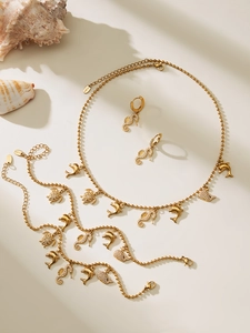 Detailed set of gold ocean-themed jewelry with shell, turtle, and seahorse charms