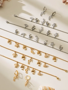 Close-up of gold and silver ocean themed jewelry sets with zircon starfish and seahorse