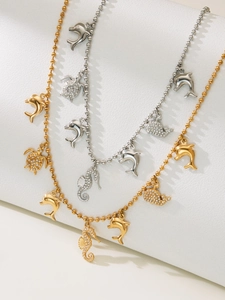 Close-up of gold and silver beaded necklaces with crystal sea turtle and seahorse charms