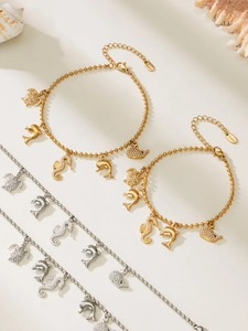 Detailed view of silver marine life bracelets with turtle and seahorse charms on shells