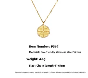 Detail of round gold pendant with IC XC NI KA engraving and zircon inlay on steel chain