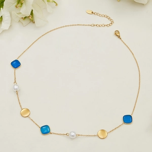 Gold stainless steel necklace with blue square gems, white pearls and metallic discs