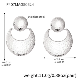 Macro view of silver crescent stainless steel earrings with dimensions 4.1cm by 2.8cm
