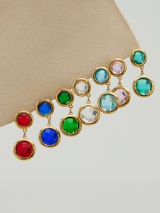 Detailed view of dangling round colorful zircon earrings with gold-plated metal frames