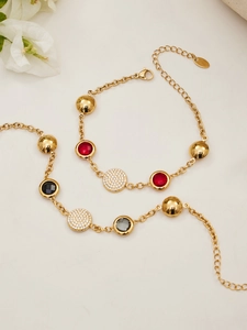 Detail of gold chain jewelry set with colorful gemstones and pavé crystal charms