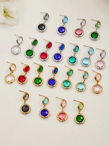 Detailed close-up of multi-colored zircon crystal stud earrings in gold and silver plating