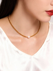 Close-up of a minimalist 18K gold plated curb chain necklace with a single lustrous pearl