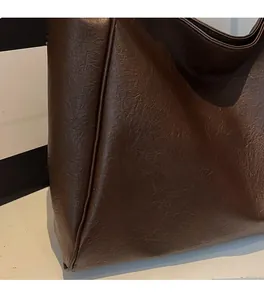 Close-up of brown tote bag showing soft leather texture and premium material detail
