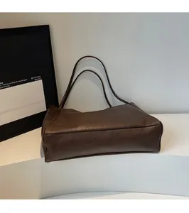 Close-up of a deep coffee vintage tote bag made of high-quality matte synthetic leather