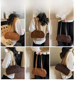 Detail view of vintage baguette shoulder bags in caramel brown and dark coffee suede