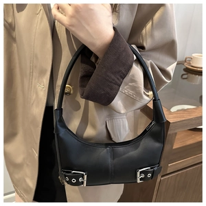 Detail of black crescent hobo bag featuring vintage silver metal buckles and leather belts