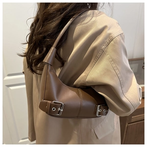 Detailed view of dark brown crescent hobo bag with silver buckle and matte leather texture