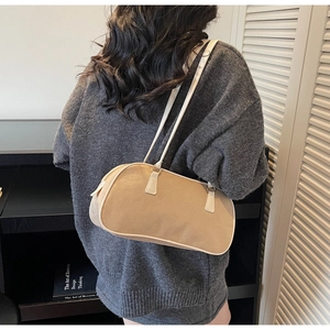 Retro beige suede baguette shoulder bag with white leather trim shown on model