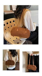 Detail view of a vintage brown suede baguette bag with slim shoulder straps