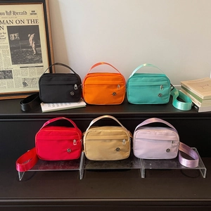 Minimalist square crossbody bags in six vibrant colors with nylon fabric and top handles