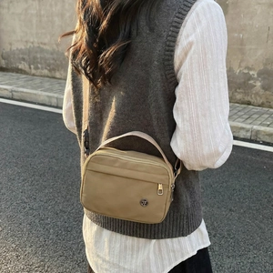 Khaki nylon crossbody bag for men and women with adjustable strap and TF metal logo