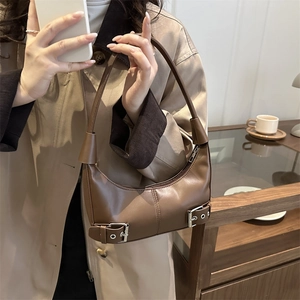 Brown leather hobo shoulder bag with silver buckle details and minimalist half-moon design
