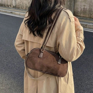 Retro dark brown faux suede baguette shoulder bag styled with a khaki trench coat