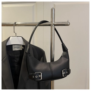 Detail of black crescent hobo bag with silver buckle straps and adjustable shoulder strap