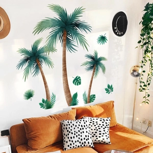 Tropical palm trees and green leaves wall stickers decorating a cozy living room wall