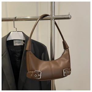 Detail view of brown hobo crescent bag with silver buckles and smooth matte leather finish