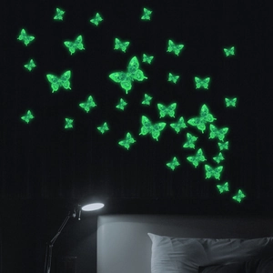Luminous glow-in-the-dark butterfly wall stickers for bedroom decor in a night setting