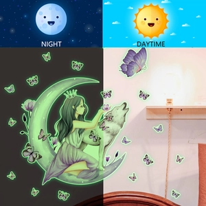 Luminous wall sticker showing glowing girl on moon and butterfly in day and night contrast