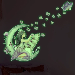 Detailed view of luminous wall stickers with moon, girl, wolf, and butterfly motifs in glow effect