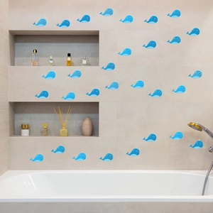 Blue whale cartoon wall stickers applied on marble bathroom wall near white bathtub