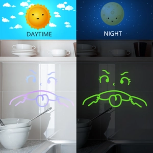 Luminous emoji wall sticker showing side-by-side daytime and glowing green night effect