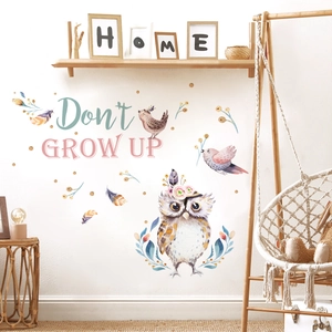 Detail showing cartoon owl wall stickers with birds and feathers in nursery room decor