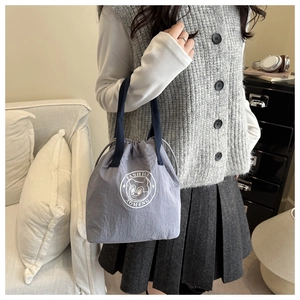 Close-up of stylish lavender waterproof Oxford tote with cartoon bear print and blue straps