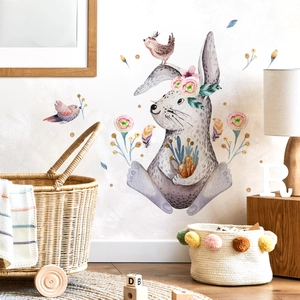 Nursery wall sticker with watercolor rabbit, pink birds and floral details on white wall