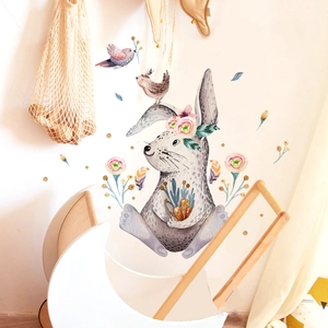 Detail of watercolor rabbit wall sticker with birds and leaves in children nursery room