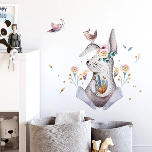 Detailed view of watercolor bunny and flower wall decals in a cozy nursery room setting