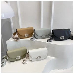 Saddle crossbody bags in five colors with G-buckle and wave-patterned straps on display